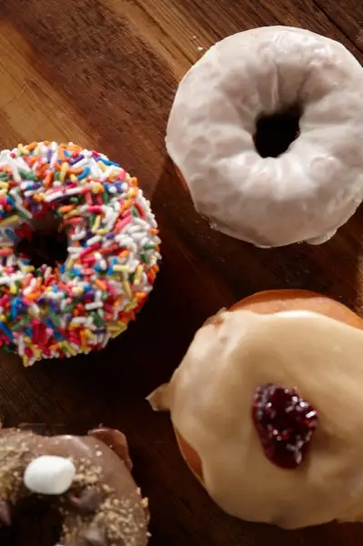Assorted sprinkle, glazed and jelly doughnuts