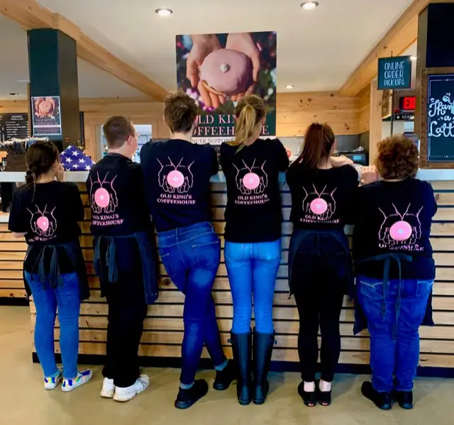 The crew in matching shirts lined up at the counter