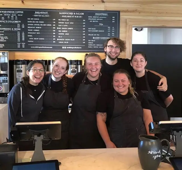 The Hyannis crew smiling behind the counter