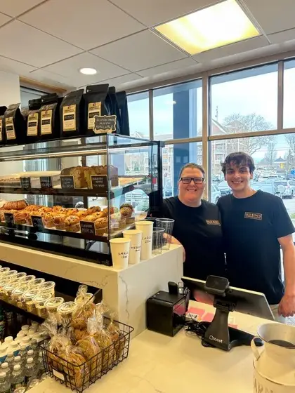 Tara and Kyle behind the retail coffee shelves